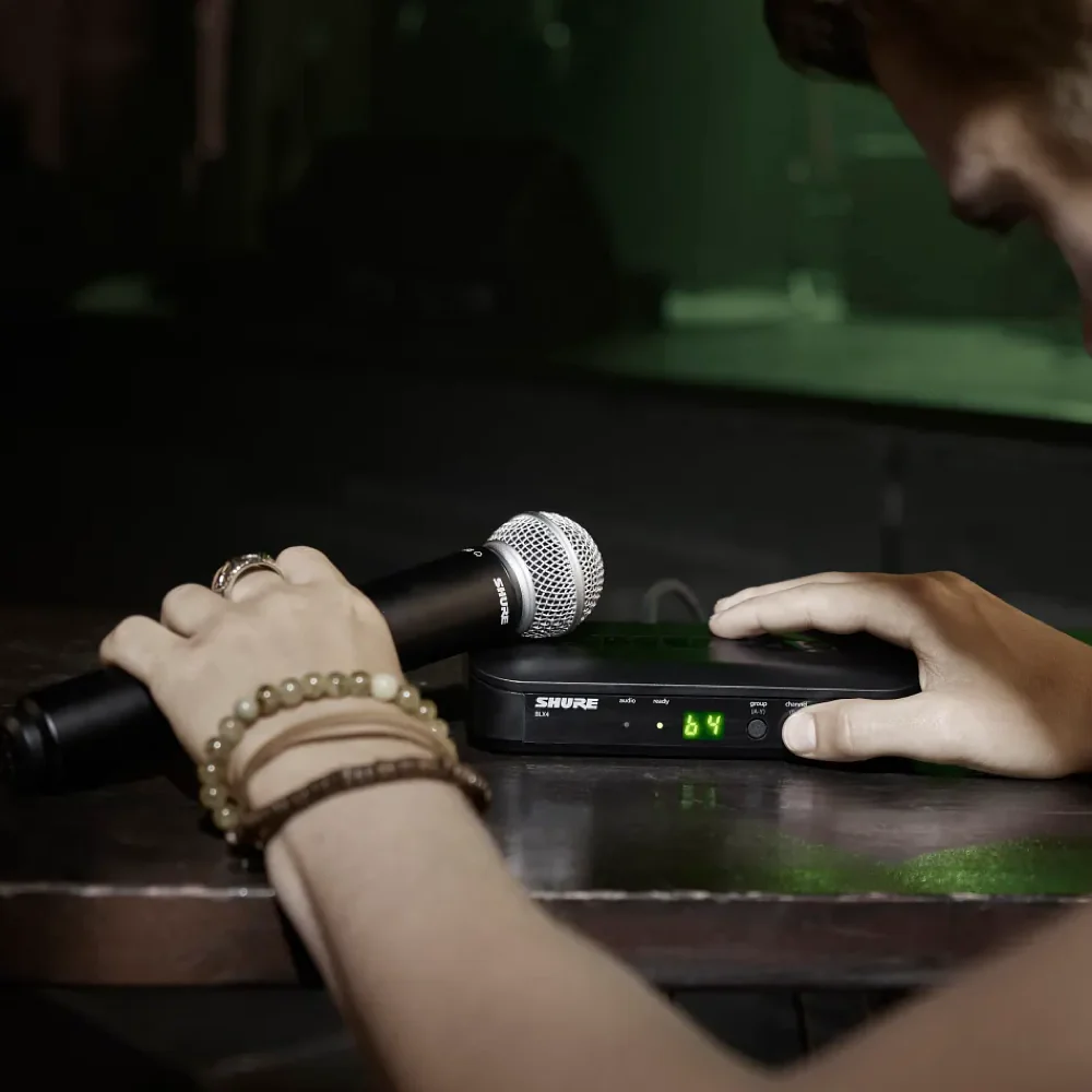 Shure BLX4 alıcısında tek dokunuşla frekans tarama ve senkronizasyon; yanında SM58 kapsüllü el vericisi
